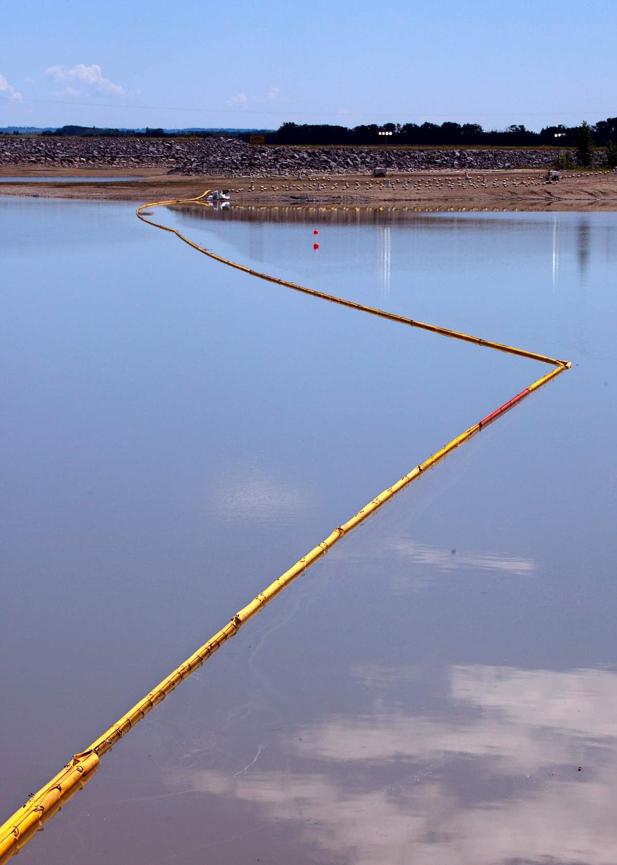 A boom stretches out to contain a pipeline leak on the Gleniffer reservoir near Innisfail, Alta., Tuesday, June 12, 2012. 