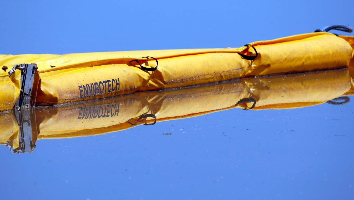A boom stretches out to contain a pipeline leak on the Gleniffer reservoir near Innisfail, Alta., Tuesday, June 12, 2012. Jeff McIntosh/Canadian Press