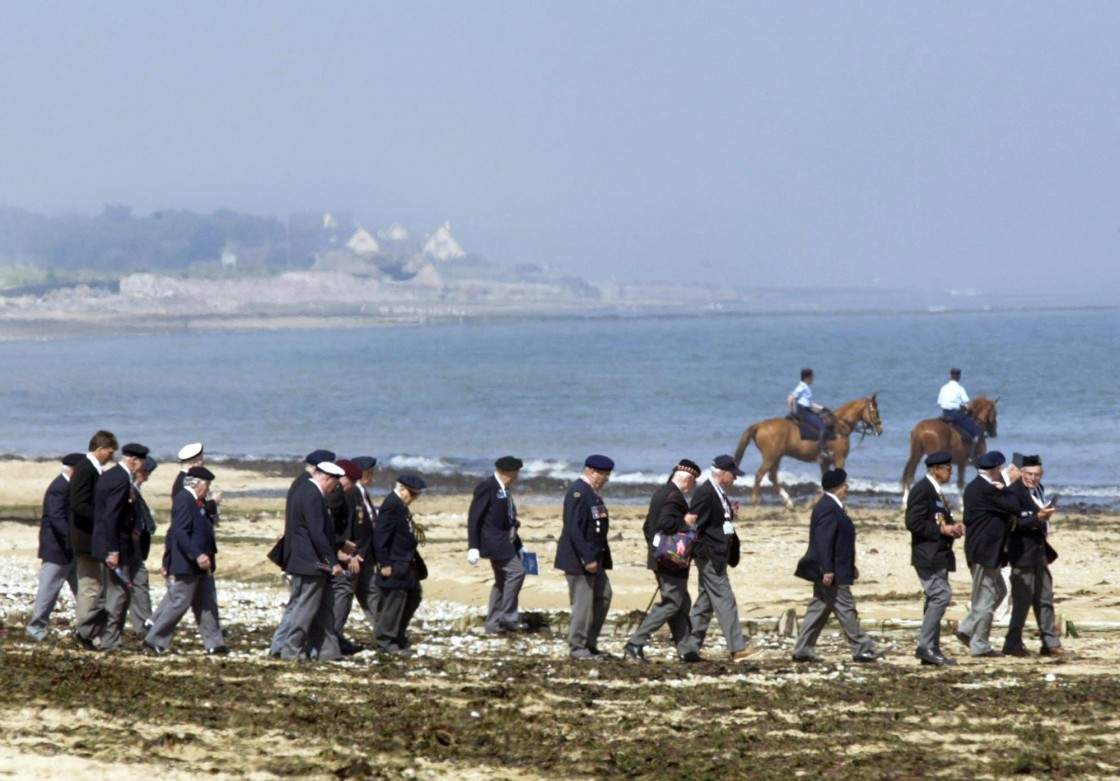 Canadian veterans make their way down Juno beach to the water's edge following a ceremony marking the 60th Anniversary of D-Day in Courseulles-sur-Mer, France, on the Normandy coast on June 6, 2004. The view could change if a plan to build an army of wind turbines some 10 kilometres off the shore succeeds.
