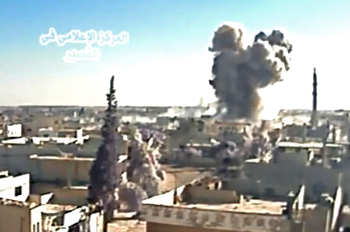 A image grab taken from a video uploaded on Youtube by Al-Qusayr Media Centre on May 26, 2013 allegedly shows smoke billowing from buildings in the city of Qusayr, in Syria's central Homs province, following an airstrike by government forces. 