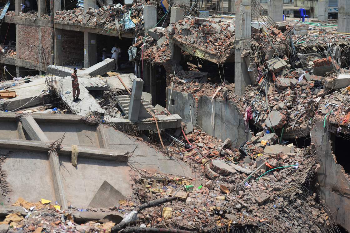 A Bangladeshi firefighter stands amid the debris as rescue and army personnel continue recovery operations after the eight-storey building collapsed in Savar, on the outskirts of Dhaka, on May 3, 2013. 