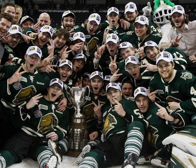 London's Knights surround the Ontario Hockey League Championship trophy after Game 7 action against the Barrie Colts on Monday, May 13, 2013 in London, Ont.