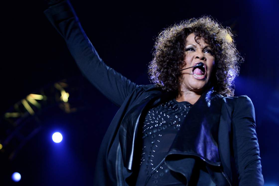 Whitney Houston performing live onstage.