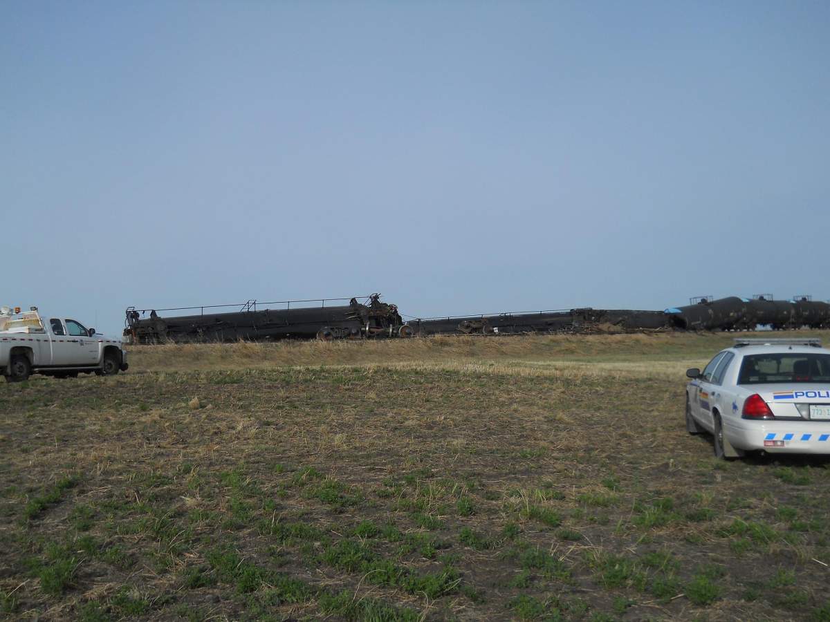 Dirt containment wall built when oil leaks after Saskatchewan train derailment.