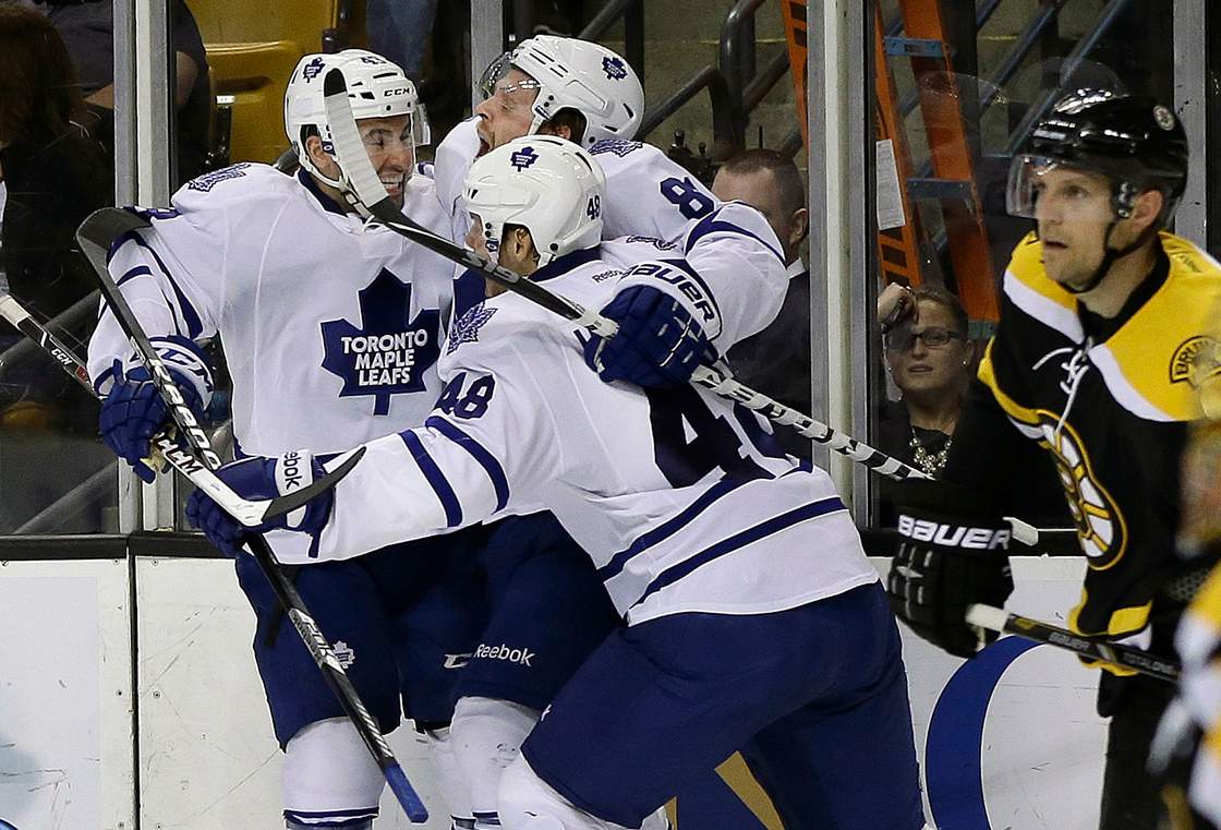 Toronto Maple Leafs right wing Phil Kessel (81) celebrates his goal with left wing Ryan Hamilton (48) and center Nazem Kadri (43) as Boston Bruins defenseman Dennis Seidenberg, right, looks on during the third period in Game 2 of a first-round NHL hockey playoff series in Boston, Saturday, May 4, 2013. 