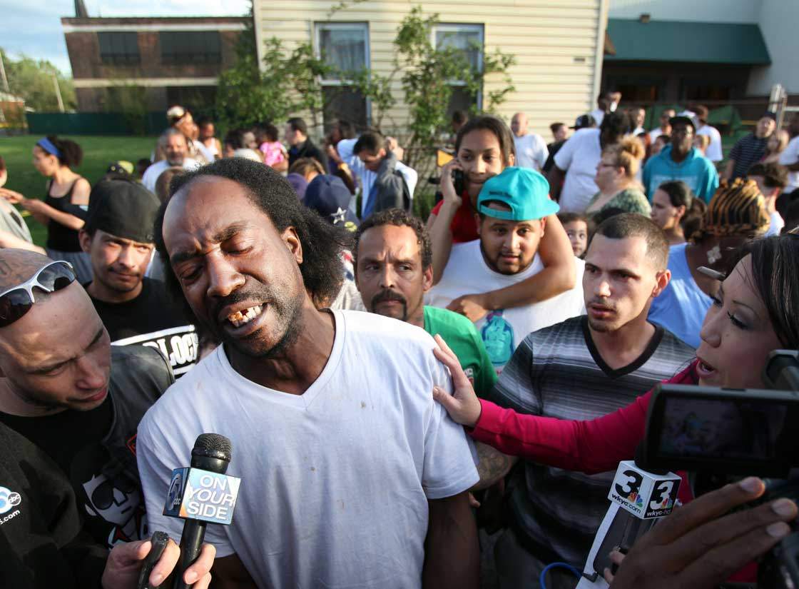 Neighbour Charles Ramsey speaks to media near the home on the 2200 block of Seymour Avenue, where three missing women were rescued in Cleveland, on Monday, May 6, 2013. Cheering crowds gathered on the street where police said Amanda Berry, Gina DeJesus and Michele Knight, who went missing about a decade ago and were found earlier in the day.