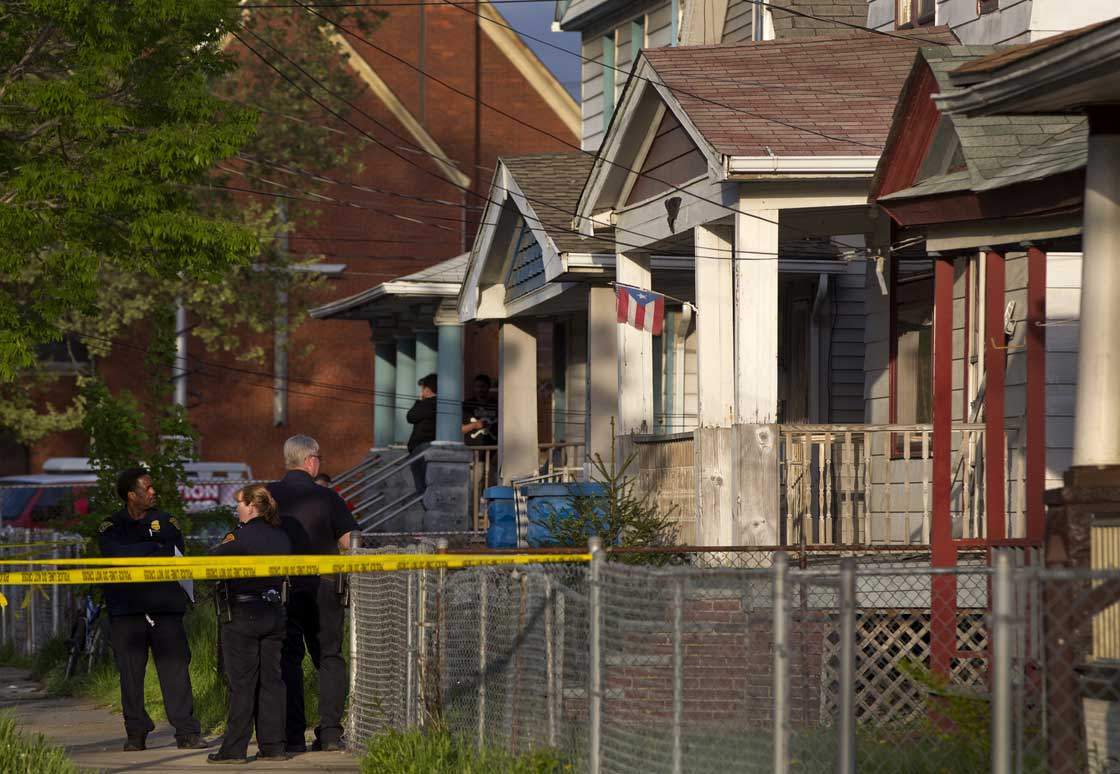 Cleveland Police stand outside a home where they say missing women, Amanda Berry, Gina DeJesus and Michele Knight were found in the 2200 block of Seymour Avenue in Cleveland on Monday, May 6, 2013. The three women who went missing about a decade ago were found alive in a residential area just south of downtown.