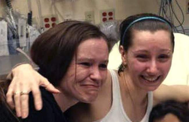 File photo - Amanda Berry, right, hugs her sister Beth Serrano after being reunited in a Cleveland hospital Monday May 6, 2013. 