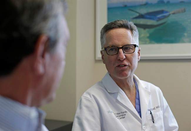Prostate cancer patient Dean Smith, left, a retired marketing executive, meets with Dr. Peter Carroll, right, at the UCSF Medical Center in San Francisco on Thursday, May 2, 2013.