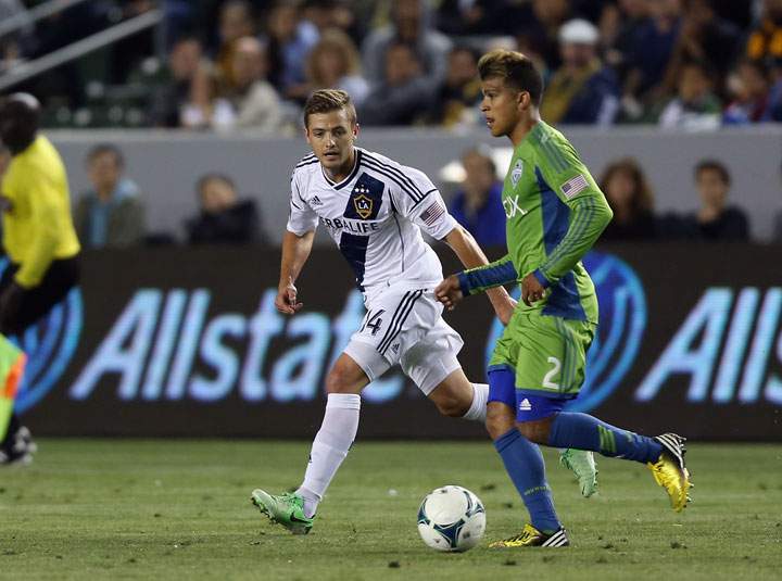 Robbie Rogers of L.A. Galaxy pursues Deindre Yedlin of Seattle Sounders FC for the ball in the second half at The Home Depot Center on May 26, 2013 in Carson, California.