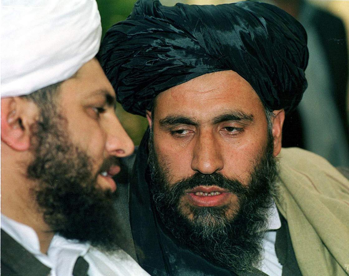 File - Taliban second most senior figure, Mullah Mohammad Rabbani (R),  consults with Taliban ambassador in Pakistan Syed Mohammad Haqqani during a press conference in Islamabad, 01 February 2000. 