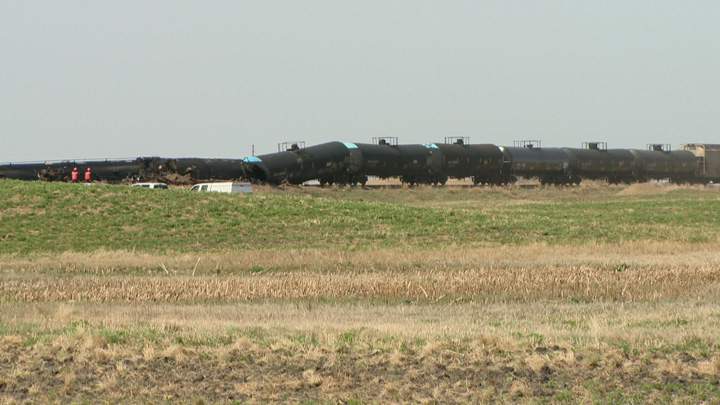 Dirt containment wall built when oil leaks after Saskatchewan train derailment.