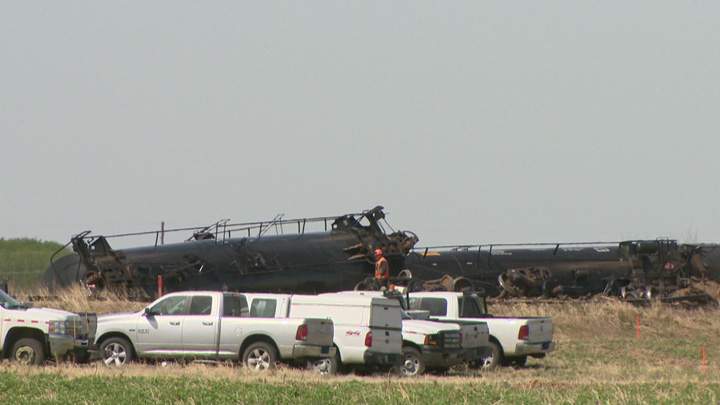 Dirt containment wall built when oil leaks after Saskatchewan train derailment.