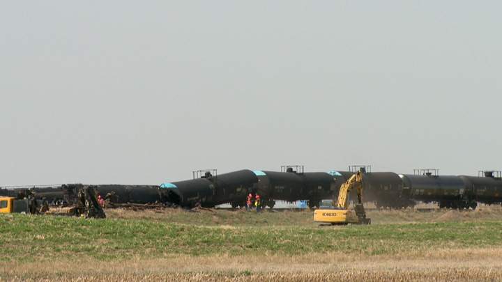 Dirt containment wall built when oil leaks after Saskatchewan train derailment.