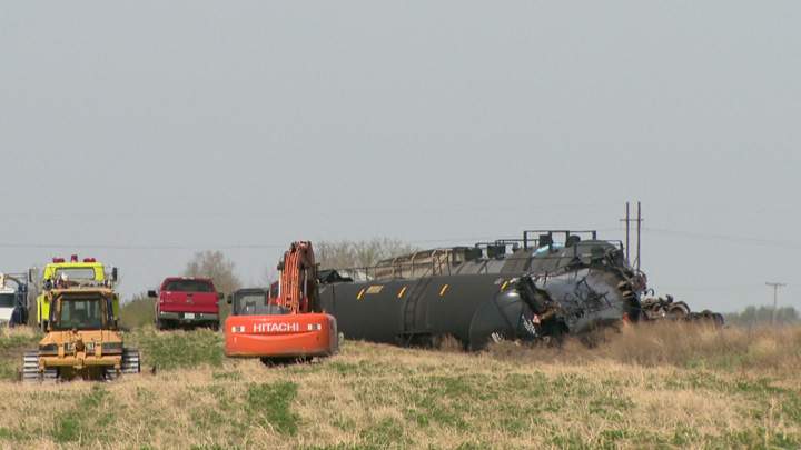 Dirt containment wall built when oil leaks after Saskatchewan train derailment.
