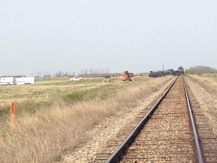 Dirt containment wall built when oil leaks after Saskatchewan train derailment.