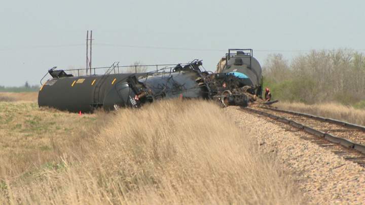 Dirt containment wall built when oil leaks after Saskatchewan train derailment.