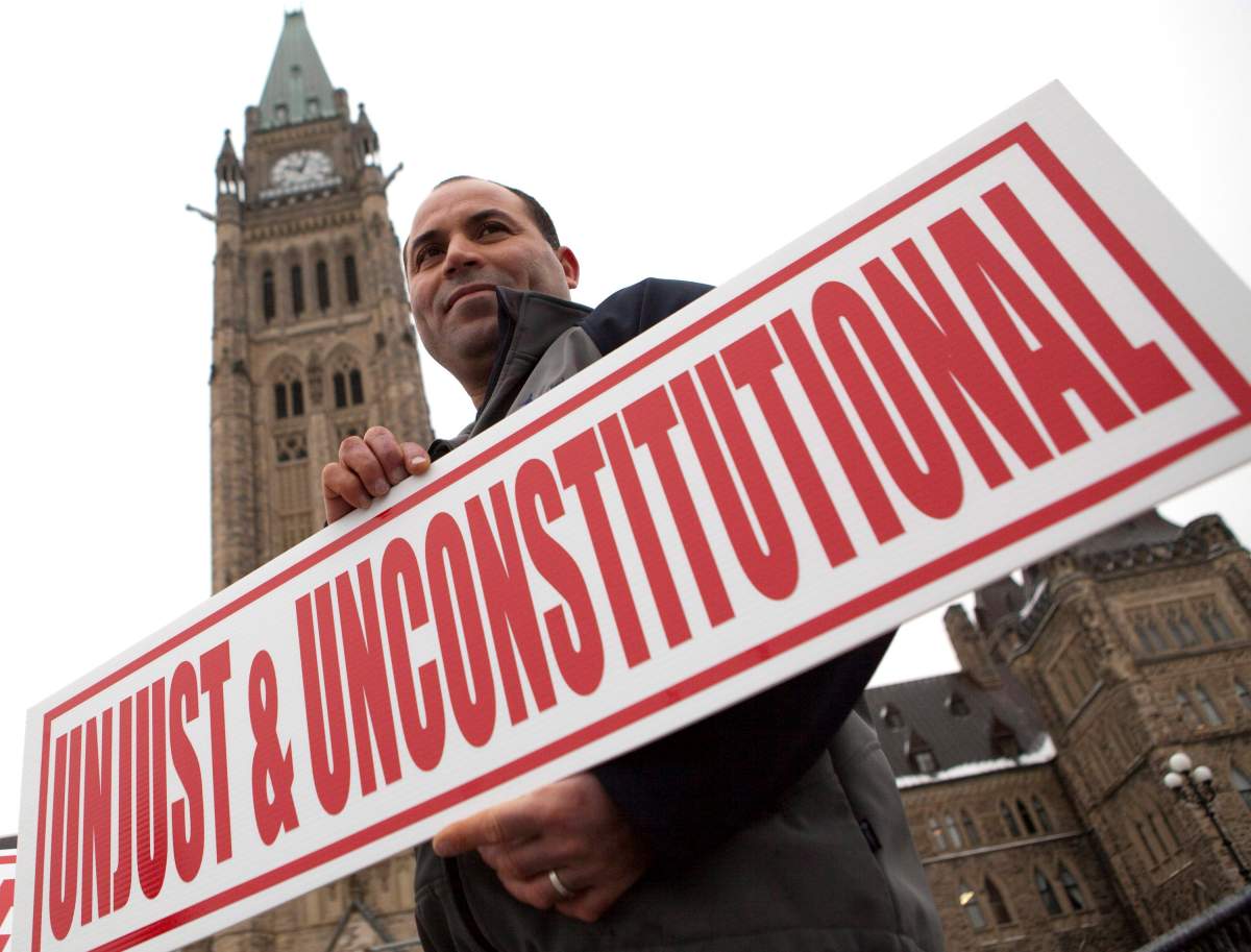 ohamed Harkat participates in a rally on Parliament Hill marking the 10th anniversary of his arrest and detention on a security certificate, Monday, Dec. 10, 2012, in Ottawa.