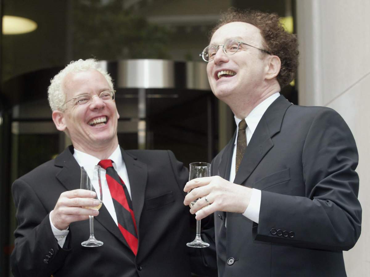 Michael Stark (left) and Michael Leshner celebrate with champagne after their marriage in Superior Court in Toronto on Tuesday, June 10, 2003. The couple have been together for 22 years and were finally allowed to marry following a court ruling Tuesday morning.