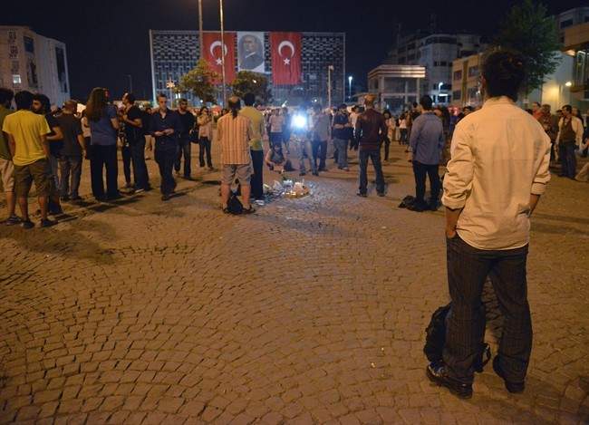 Erdem Gunduz, right, stands silently on Taksim Square in Istanbul, Turkey, early Tuesday, June 18, 2013. 