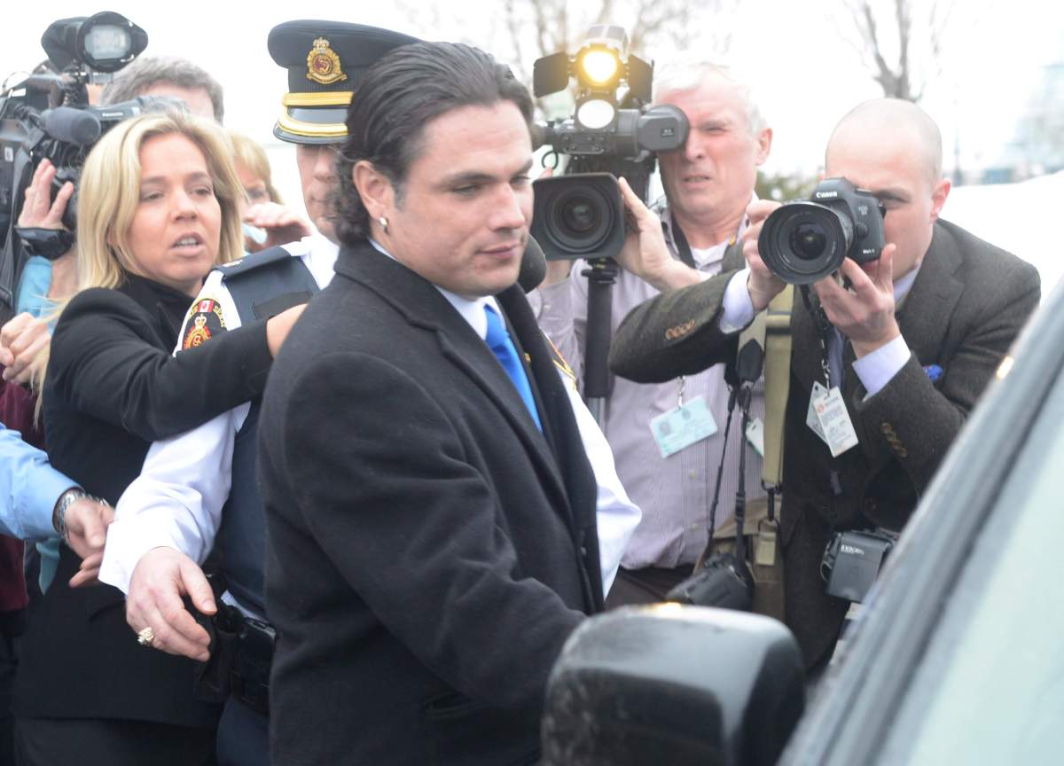 Sen. Patrick Brazeau enters a vehicle on Parliament Hill in Ottawa, Tuesday, Feb.12, 2013. Senators have voted to force Brazeau, who is facing criminal charges, to take a leave of absence from the upper chamber.THE CANADIAN PRESS/Adrian Wyld.