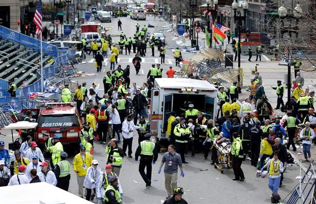 In this April 15, 2013 file photo, medical workers aid injured people at the finish line of the 2013 Boston Marathon following an explosion in Boston. 