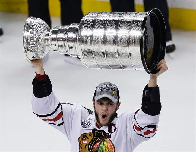 Chicago Blackhawks’ Jonathan Toews hoists the Stanley Cup after defeating the Boston Bruins 3-2 in Game 6 to win the NHL hockey Stanley Cup Finals, Monday, June 24, 2013, in Boston.