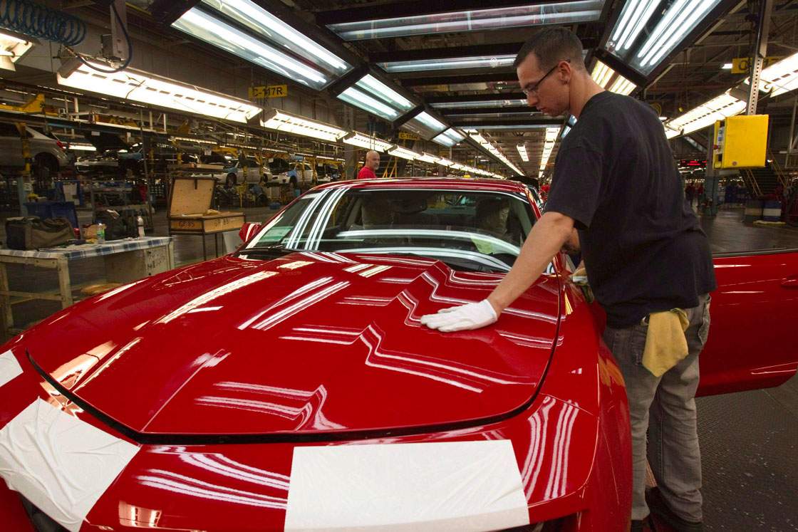 An assembly line worker tends to a Camaro at GM Canada’s “flex” line in Oshawa. Production of the next-generation model is being shifted to a Michigan plant beginning in 2015.