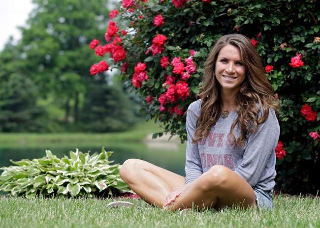 Mandi Grandjean sits outside her home in Canton, Ohio Wednesday, June 12, 2013. Grandjean, a recent graduate of Miami University in Ohio, says she's fine with the government doing secret surveillance of phone call records and Internet exchanges, but believes it's different when it comes to an employer, or even a coach. 
