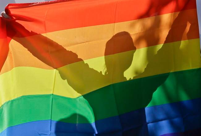 File photo - An activist holds up a Pride Flag in Kiev, Ukraine, on May 25, 2013. Canadian military personnel are being encouraged to attend Pride events in uniform by Canada's top soldier, Wednesday, August 2, 2017.