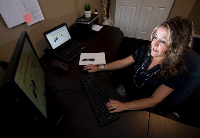 Ana Aresta works from her home in Delta, B.C. on Thursday, June 20, 2013.