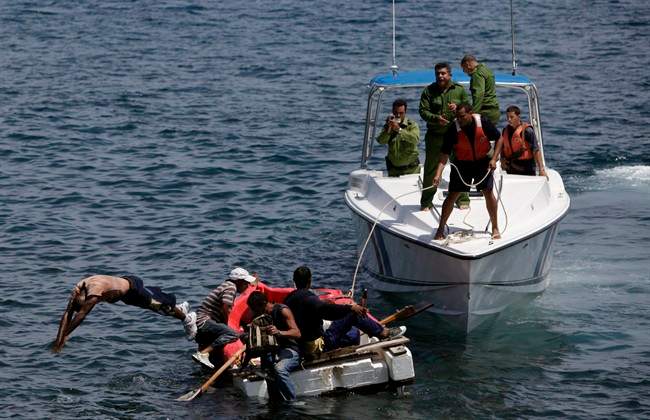 Cuban coast guards stop seven men trying to migrate illegally to the U.S. on a foam raft in 2009.