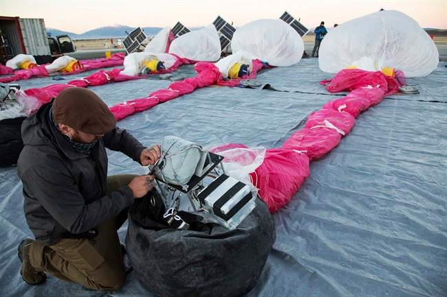 In this June 10, 2013 photo released by Google, Jordan Miceli prepares electronics to launch balloons in Tekapo, New Zealand.