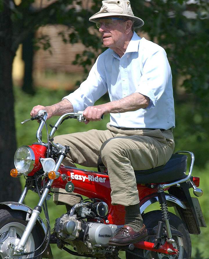 Prince Philip, the Duke of Edinburgh, rides a monkey-bike at the Royal Windsor Horse Show May 16, 2002 in Windsor, England. (Photo credit: Getty Images)