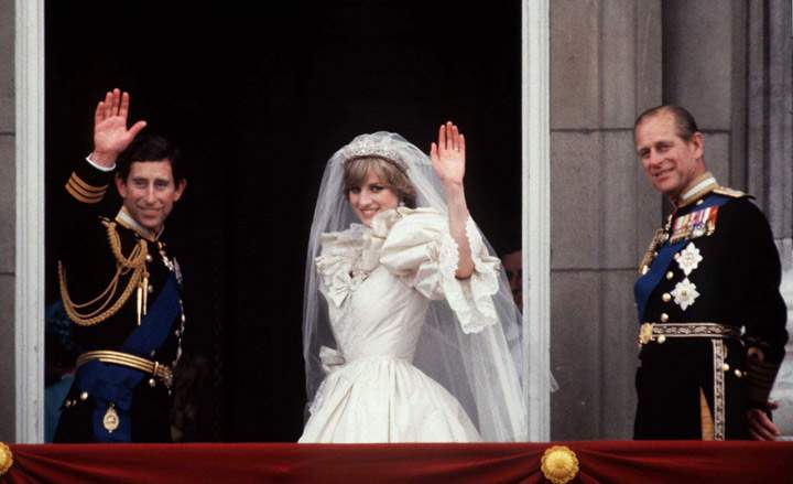 Prince Philip (R) accompanies Prince Charles and Princess Diana on their wedding day as they wave from the balcony Of Buckingham Palace on July 29, 1981.