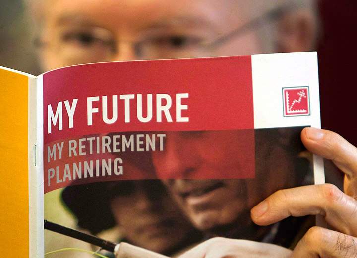 A man looks over a brochures offering various retirement savings options.