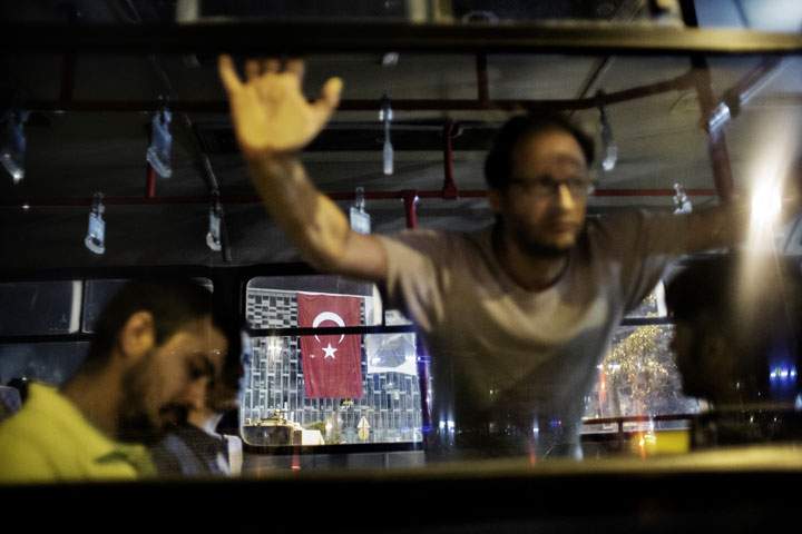 Men detained for standing on Taksim square in a lone protest are seen arrested inside a truck used by the Turkish police June 18, 2013.  