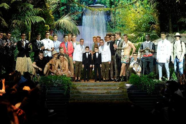 Fashion designers Dean and Dan Caten pose with models at the end of DSquared2 men's Spring-Summer 2014 collection, part of the Milan Fashion Week, unveiled in Milan, Italy, Tuesday, June 25, 2013. 
