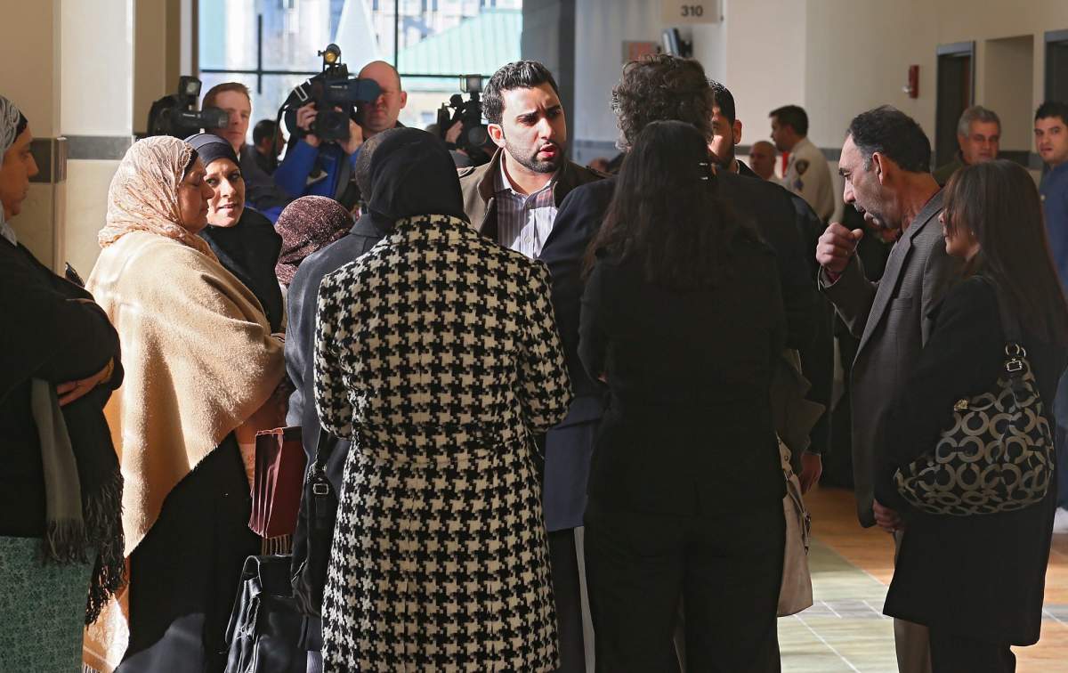Members of Nayel and Andy Ashkar's families talk with their attorney outside Onondaga County Court in Syracuse, N.Y. Wednesday, Nov. 14, 2012. Nayel and Andy Ashkar are accused of scamming a customner out of a winning $5 million scratch-off ticket.