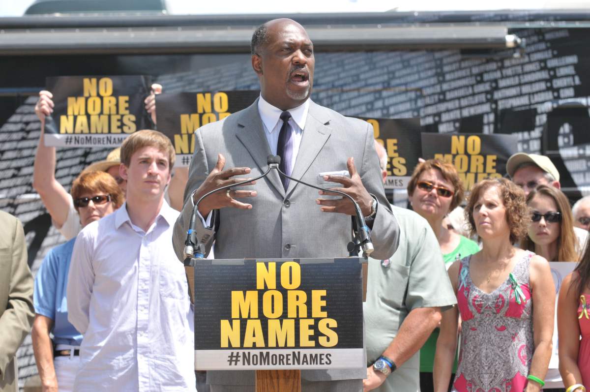 AURORA, CO - JULY 19: Pastor Del Phillips of the House Worship Center prays for victims at at a remembrance ceremony at Cherry Creek State Park July 19, 2013 in Aurora, Colorado. James Holmes killed 12 people and injured more than 50 during a mass shooting in a movie theater on July 20, 2012. Sullivan's son was killed during the shooting spree.