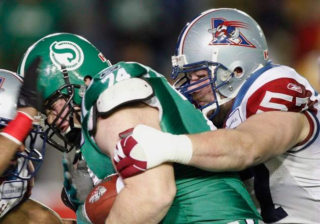 Montreal Alouettes running back Avon Cobourne (left) and guard Scott Flory (right) tackle Saskatchewan Roughriders defensive lineman Keith Shologan during first quarter Grey Cup action in Calgary, November 29, 2009. Montreal Alouettes offensive lineman Scott Flory will miss the remainder of the season after suffering a torn bicep.