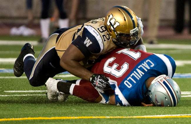 Former Winnipeg Blue Bombers defensive tackle Bryant Turner sacks Montreal Alouettes quarterback Anthony Calvillo in Montreal in July.