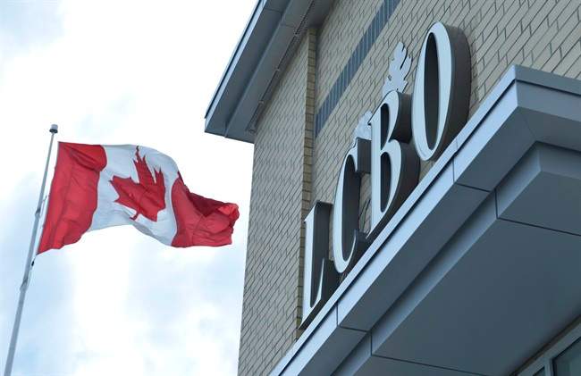 A Canadian flag flies near a LCBO store in Bowmanville, Ontario on Saturday July 20, 2013.