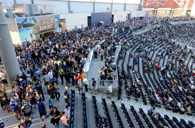 Fans walk in the concourse during the second half of the first game at Investors Group Field.