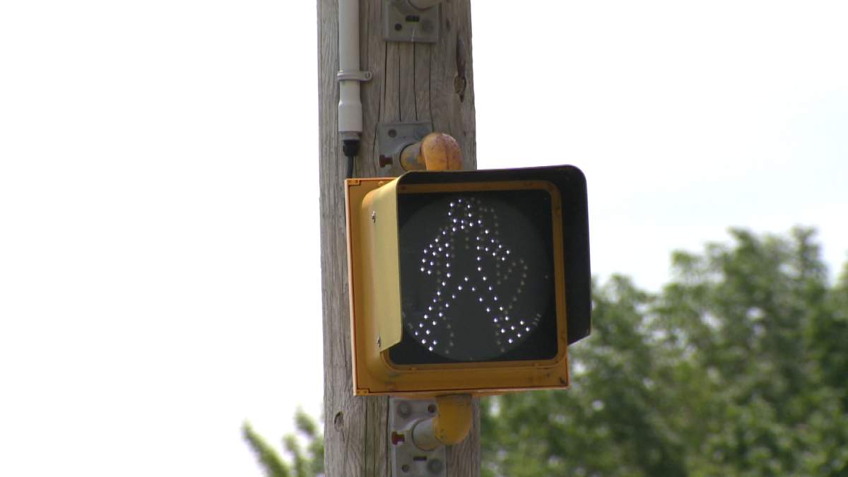 A pedestrian crossing sign .