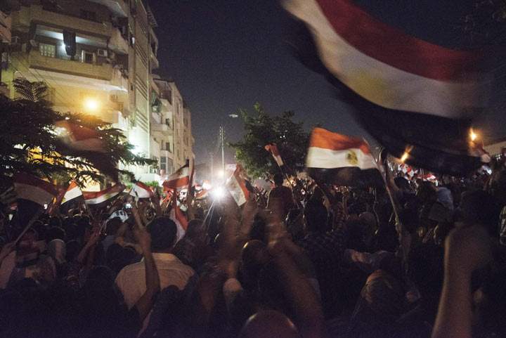 Hundreds of thousands of Egyptian demonstrators  waving national flags gather at the Egyptian Presidential Palace during a protest calling for the ouster of President Mohamed Morsi on July 1, 2013 in Cairo, Egypt. 