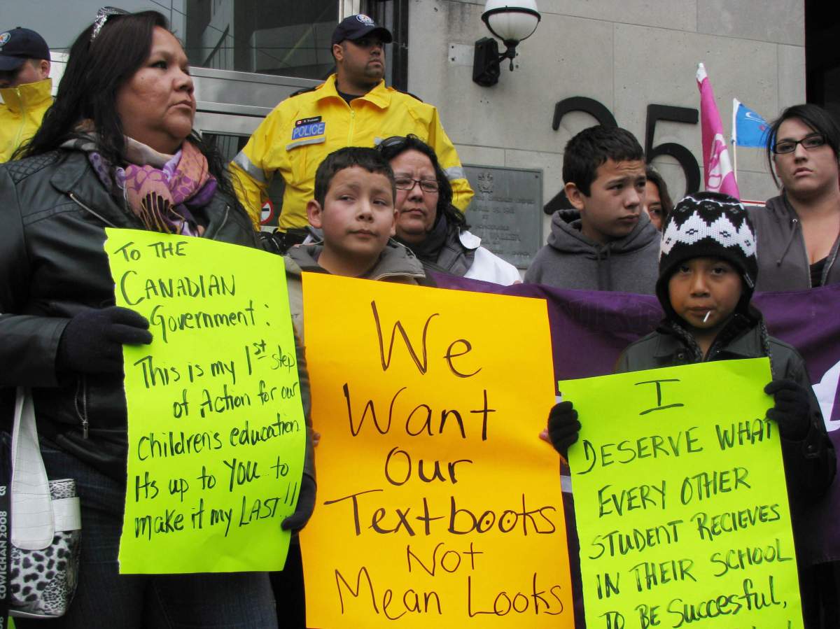 Members of the Six Nations of the Grand River reserve protest to lobby the federal government for school funding and backlogged supplies outside the government's aboriginal affairs and northern development office in Toronto, Thursday, Oct.11, 2012. THE CANADIAN PRESS/Tara Deschamps.
