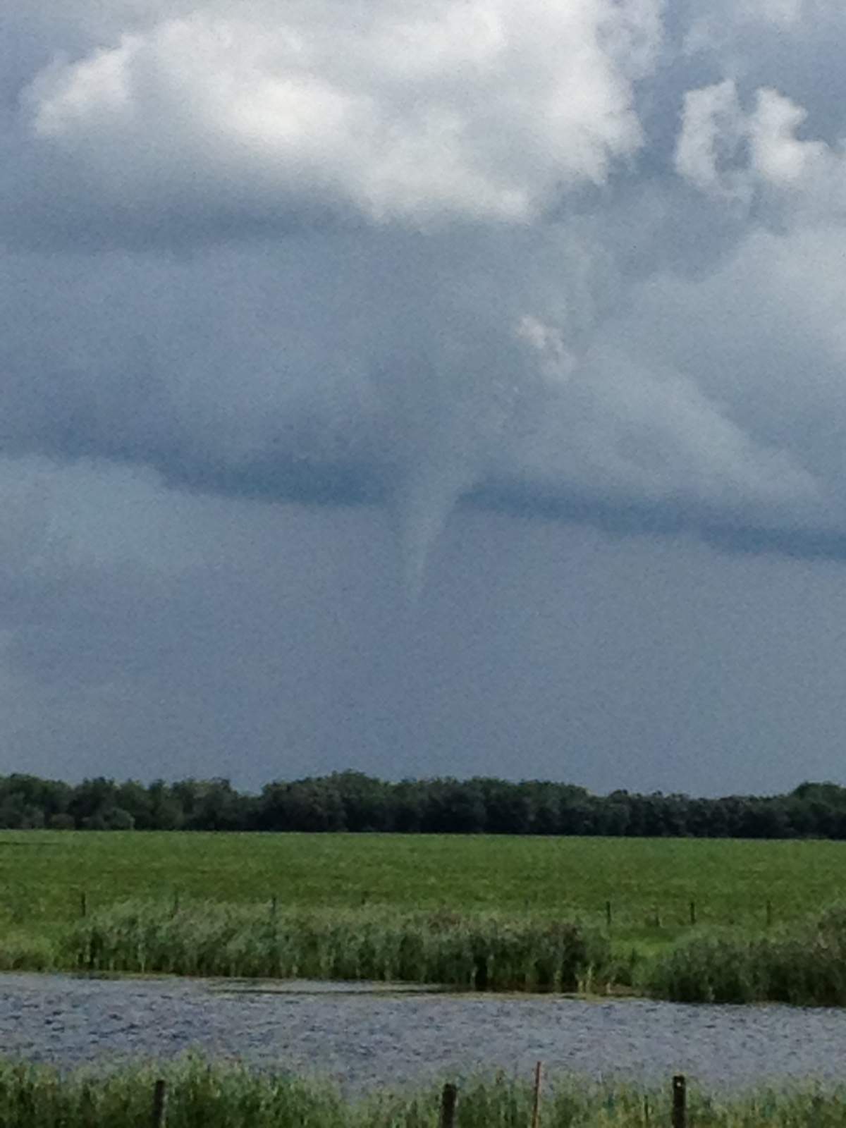 A funnel cloud forms east of Morris, Man., at about 2:30 p.m. Wednesday. Environment Canada confirmed a tornado touched down in the area at about 2:45 p.m.