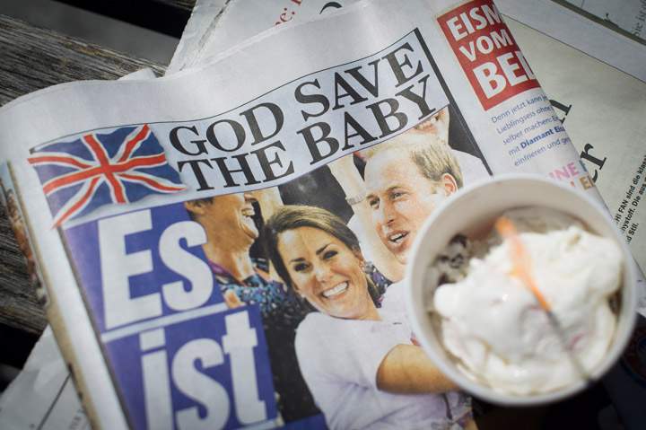 A newspaper headline reads 'God Save the Baby' the day after the birth of the son of Prince William, Duke of Cambridge and Catherine, Duchess of Cambridge on July 23, 2013 in Berlin.