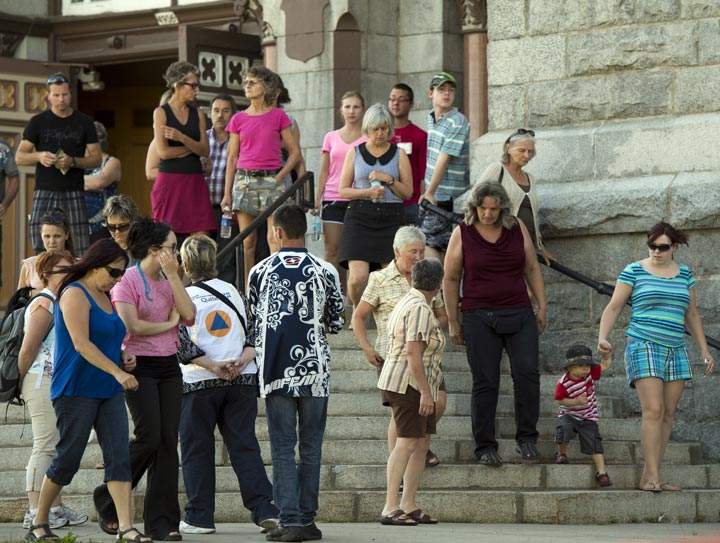 Families of the victims of the train derailment fire leave the church after seeing the crash site for the first time Thursday, July 11, 2013 in Lac-Megantic, Quebec.